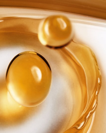 Macro photograph pf Miracle broth bubble particles on a white fluid background